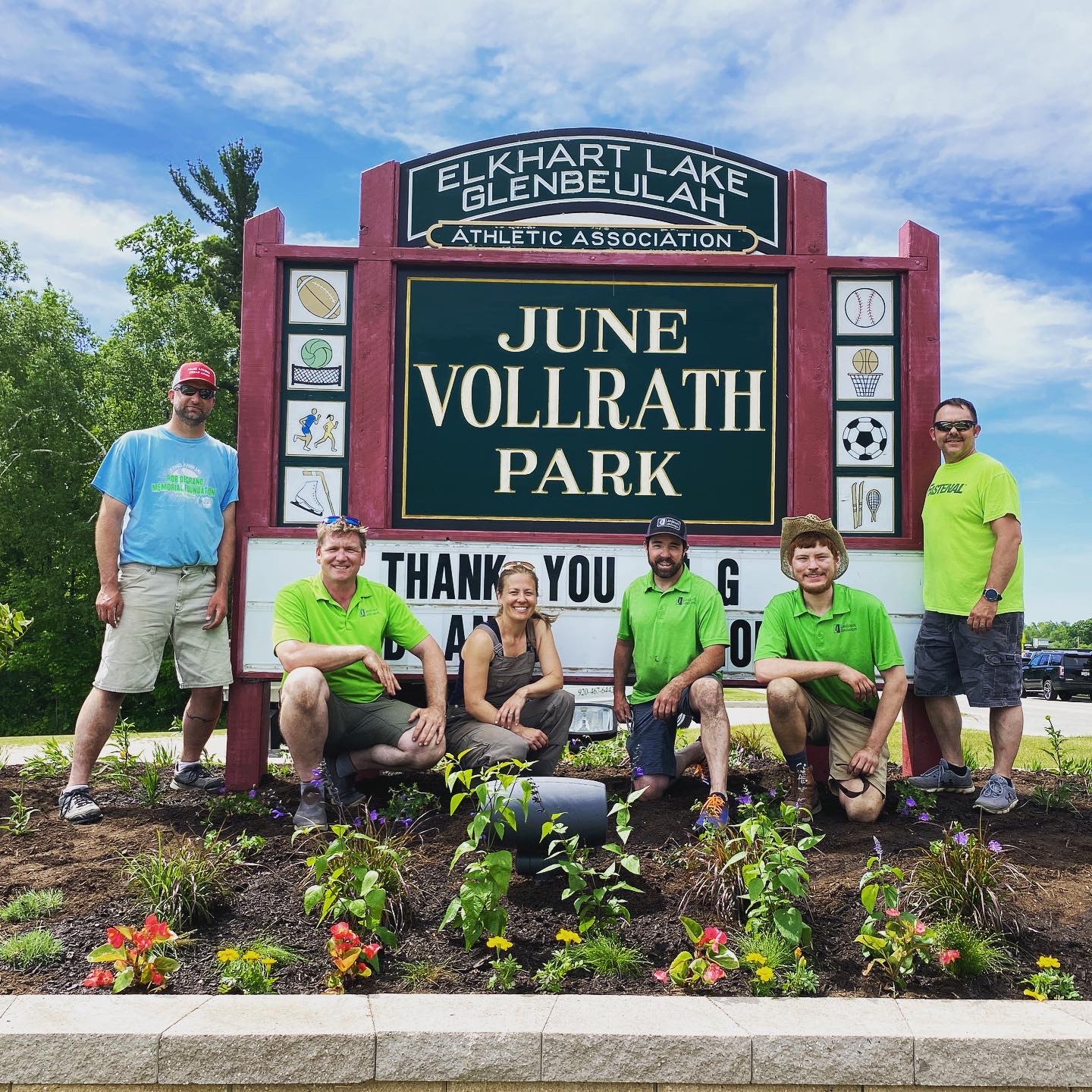 Landmark Landscapes posing with the June Vollrath Park sign